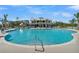 Expansive pool with clear blue water and a beautiful two-story community building in the background, surrounded by palm trees at 2237 Tillage St, Mount Pleasant, SC 29466