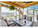 Inviting screened-in porch with dining area and views of the backyard at 2237 Tillage St, Mount Pleasant, SC 29466