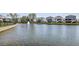 Scenic view of homes alongside a lake with a fountain, offering a tranquil living experience at 2237 Tillage St, Mount Pleasant, SC 29466