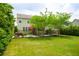 Green backyard with lawn and patio is enhanced by landscaping and mature trees at 2254 Show Basket Way, Mount Pleasant, SC 29466
