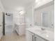 Bright bathroom featuring double sinks, mirrors, and white cabinets at 2254 Show Basket Way, Mount Pleasant, SC 29466