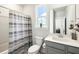 Bright bathroom featuring a gray striped shower curtain, and gray vanity with white sink at 2632 Private Lefler Dr, Johns Island, SC 29455