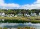 Beautiful street view showcasing lovely homes surrounding a serene pond and lush trees at 2632 Private Lefler Dr, Johns Island, SC 29455