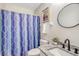 Clean bathroom with a shower, granite vanity, and stylish round mirror for a refreshing and practical design at 2777 Forest Dew Ct, Charleston, SC 29414