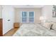 Bright bedroom with light-colored walls, two windows, and a comfortable bed with a patterned duvet at 2777 Forest Dew Ct, Charleston, SC 29414