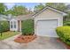 Exterior view showing attached garage and well-maintained landscaping around the perimeter of the home at 2777 Forest Dew Ct, Charleston, SC 29414