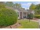 Charming home featuring a well-manicured lawn, lush greenery, and a welcoming porch area at 2777 Forest Dew Ct, Charleston, SC 29414