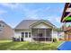 Backyard with a screened porch and plenty of green space at 280 Swamp Creek Ln, Moncks Corner, SC 29461