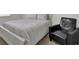 Cozy bedroom with a white bed frame and a black chair at 280 Swamp Creek Ln, Moncks Corner, SC 29461
