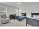 Bedroom with two navy beds, dresser, and a comfortable rocking chair at 280 Swamp Creek Ln, Moncks Corner, SC 29461