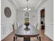 Formal dining room featuring hardwood floors, wainscoting, a chandelier, and a large window at 280 Swamp Creek Ln, Moncks Corner, SC 29461