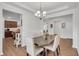 Traditional dining room with hardwood floors, elegant chandelier, and a view of the kitchen at 280 Swamp Creek Ln, Moncks Corner, SC 29461