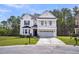 Charming two-story home with a second story balcony, attached garage, and well-manicured lawn at 280 Swamp Creek Ln, Moncks Corner, SC 29461