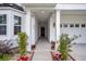 Inviting front entrance featuring a covered porch, white columns, and meticulously arranged potted flowers at 280 Swamp Creek Ln, Moncks Corner, SC 29461
