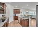 Well-lit kitchen showcasing dark wood cabinetry, granite countertops, stainless steel appliances, and hardwood floors at 280 Swamp Creek Ln, Moncks Corner, SC 29461