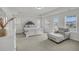 Bright main bedroom with tray ceiling, chair, and access to a private balcony at 280 Swamp Creek Ln, Moncks Corner, SC 29461