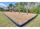 A playground with swings and slides. The ground is covered with engineered wood fiber at 280 Swamp Creek Ln, Moncks Corner, SC 29461