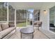 Relaxing screened porch with comfortable seating and a view of the wooded backyard at 280 Swamp Creek Ln, Moncks Corner, SC 29461