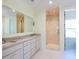 Bright bathroom with double sink vanity, marble countertops, and a glass-enclosed shower at 295 W Coleman Blvd, Mount Pleasant, SC 29464