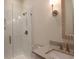 Modern bathroom featuring a marble vanity, decorative mirror, and frameless glass shower with gold hardware at 295 W Coleman Blvd, Mount Pleasant, SC 29464
