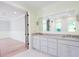 Bright bathroom with double sink vanity and large framed mirror that opens to the bedroom at 295 W Coleman Blvd, Mount Pleasant, SC 29464