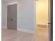 Bright bedroom with neutral walls, hardwood floors, closet, and entry to a mudroom with a bench and hooks at 295 W Coleman Blvd, Mount Pleasant, SC 29464