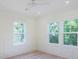 Bright bedroom featuring white trim, wainscoting, a ceiling fan, recessed lighting and two large windows at 295 W Coleman Blvd, Mount Pleasant, SC 29464