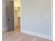 A bedroom with light wood floors, a light gray wall and a door opening into a walk in closet at 295 W Coleman Blvd, Mount Pleasant, SC 29464