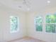 Bright bedroom featuring white trim, wainscoting, a ceiling fan, recessed lighting and two large windows at 295 W Coleman Blvd, Mount Pleasant, SC 29464