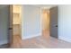 Open bedroom with closet, light hardwood floors, neutral paint, and two open doors that enhance the sense of space at 295 W Coleman Blvd, Mount Pleasant, SC 29464