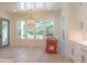 Sun-drenched dining area featuring an elegant chandelier, large windows, and modern cabinets with brass hardware at 295 W Coleman Blvd, Mount Pleasant, SC 29464