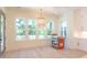 Sunlit dining area with large windows overlooking the porch, an elegant chandelier, and stylish cabinetry at 295 W Coleman Blvd, Mount Pleasant, SC 29464