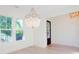 Dining room with wood floors and a chandelier, featuring abundant natural light and a view to the outside at 295 W Coleman Blvd, Mount Pleasant, SC 29464