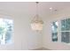 Bright dining room with wood floors, elegant chandelier and three large windows at 295 W Coleman Blvd, Mount Pleasant, SC 29464