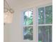 Partial view of a dining room, with hanging chandelier and large windows at 295 W Coleman Blvd, Mount Pleasant, SC 29464