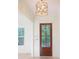Entryway featuring a wooden front door with glass, a modern light fixture, and white wainscoting at 295 W Coleman Blvd, Mount Pleasant, SC 29464