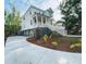 Beautiful two-story home featuring a spacious front porch, manicured landscaping, and a concrete driveway at 295 W Coleman Blvd, Mount Pleasant, SC 29464