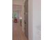 Hallway view showcasing hardwood floors, a gray door, and the kitchen in the background at 295 W Coleman Blvd, Mount Pleasant, SC 29464