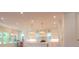 Bright, airy kitchen with white cabinets, marble countertops, stylish pendant lighting, and ample natural light from large windows at 295 W Coleman Blvd, Mount Pleasant, SC 29464