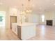Bright, white kitchen featuring marble countertops, gold accents, stylish pendant lights, and stainless steel appliances at 295 W Coleman Blvd, Mount Pleasant, SC 29464