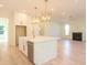 Bright, white kitchen featuring marble countertops, gold accents, stylish pendant lights, and stainless steel appliances at 295 W Coleman Blvd, Mount Pleasant, SC 29464