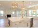 Bright kitchen island with a white farmhouse sink, gold fixtures, marble countertops, and stylish pendant lighting at 295 W Coleman Blvd, Mount Pleasant, SC 29464
