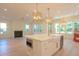 Bright kitchen island with a white farmhouse sink, gold fixtures, marble countertops, and stylish pendant lighting at 295 W Coleman Blvd, Mount Pleasant, SC 29464
