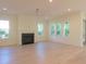 Spacious living room with light hardwood floors, fireplace, and large windows providing ample natural light and outside views at 295 W Coleman Blvd, Mount Pleasant, SC 29464