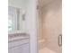 Elegant marble-tiled shower with a built-in seat and glass door that opens to vanity at 295 W Coleman Blvd, Mount Pleasant, SC 29464