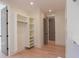 Walk-in closet with light wood floors, built-in shelving and a view into another room at 295 W Coleman Blvd, Mount Pleasant, SC 29464