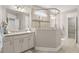 This primary bathroom features a glass enclosed shower and granite vanity at 3005 Aura Ln, Summerville, SC 29483