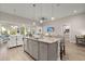 Open-concept kitchen with granite island, stainless steel appliances, and seamless flow into the dining and living areas at 3005 Aura Ln, Summerville, SC 29483