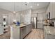 Modern kitchen features granite countertops, stainless steel appliances, and a spacious center island with pendant lighting at 3005 Aura Ln, Summerville, SC 29483
