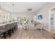Open concept living space with hardwood floors, modern furniture, and an island kitchen at 3005 Aura Ln, Summerville, SC 29483